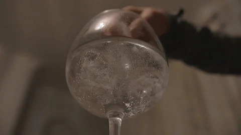 Ice Dropping into Glass Slow Motion Low Angle 3 Stock Footage 101716219