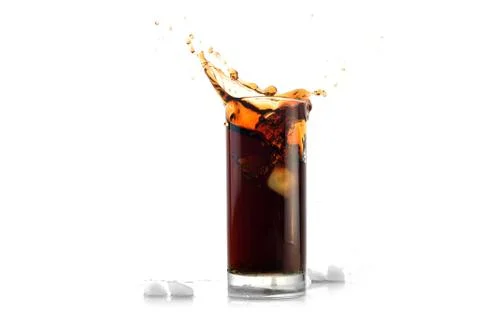 Ice drops into cola with splashes Stock Photos