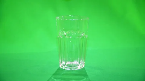 Ice falling into glass slow motion 4k chroma key Video stock 170692328