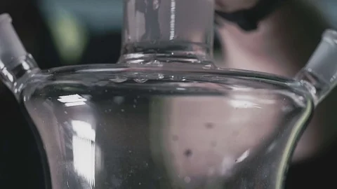 Ice falls into a shisha flask Stock Footage 77345972