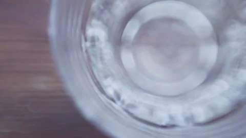 Ice flies into the glass on a dark background, close-up, top view Stock Footage 137789929