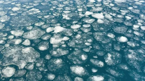Ice floating on water in a natural setting during daytime Video stock 344742019