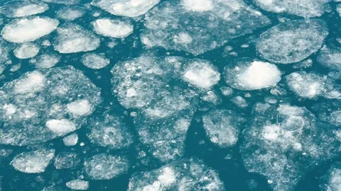 Ice floating on water in a natural setting during daytime Video stock 344742020