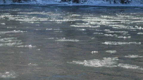 Ice floats down a mountain river. The river begins to freeze, the ice floats Stock Footage 262998789