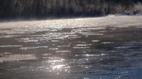 Ice floats down a mountain river. The river begins to freeze, the ice floats Stock Footage 264062112