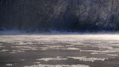 Ice floats down a mountain river. The river begins to freeze, the ice floats Stock Footage 264949448