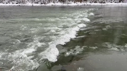 Ice floats down a mountain river. The river begins to freeze, the ice floats Stock Footage 267875355