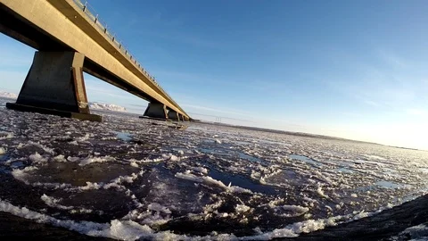 Ice floats on the water under the bridge in Eyrarbakki Iceland Stock Footage 118277288