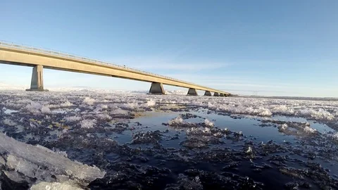 Ice floats on the water under the bridge in Eyrarbakki Iceland Stock Footage 118277560