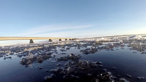Ice floats on the water under the bridge in Eyrarbakki Iceland Stock Footage 118277680