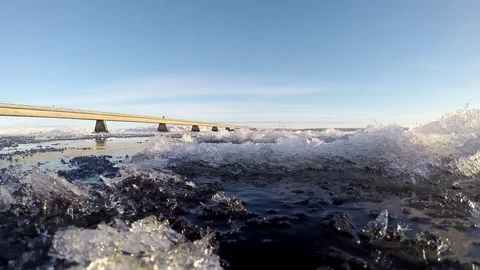 Ice floats on the water under the bridge in Eyrarbakki Iceland Stock Footage 118277943