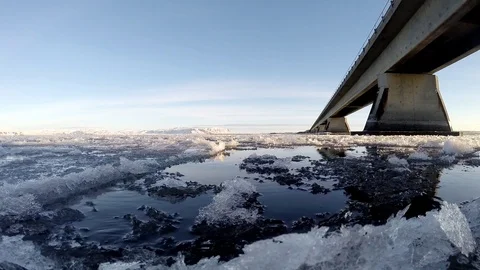 Ice floats on the water under the bridge in Eyrarbakki Iceland Stock Footage 118278129