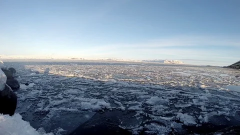 Ice floats on the water under the bridge in Eyrarbakki Iceland Stock Footage 118278191