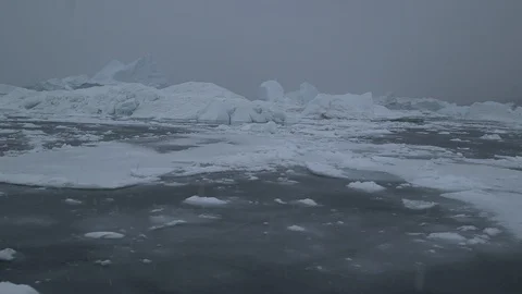 Ice floe under the falling snow in the Arctic Ocean, Greenland Video stock 102510984