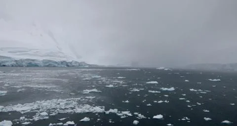 Ice floes in antarctic sea during storm, with dark ocean, Antarctica Stock Photos