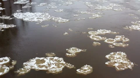 Ice floes drift along the river on a snowy day. Stock Footage 325606374