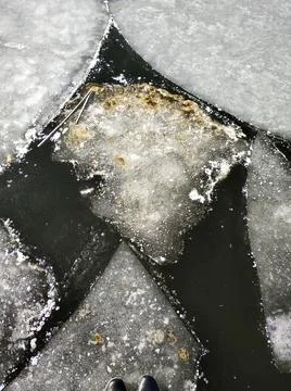 Ice floes float on the river. Thaw at the end of winter Stock Photos