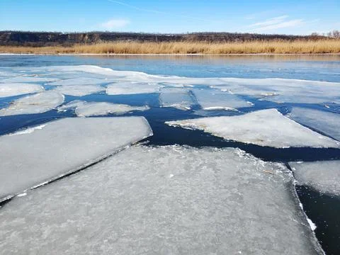 Ice floes float on the river. Thaw at the end of winter Stock Photos
