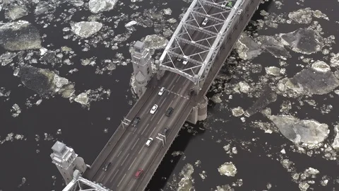 Ice floes float on the river under the bridge. cars go over the bridge Stock Footage 125797461