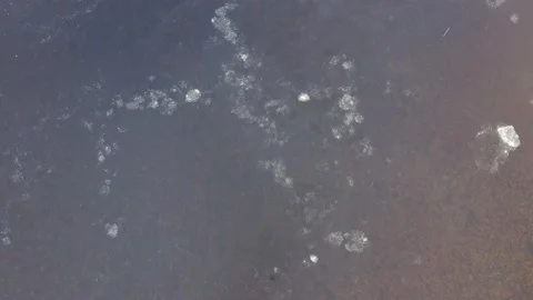 Ice Floes Moving On Cold River During Sunset and Snowfall- Static Aerial Stock Footage 205435349
