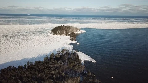 Ice flow around island Stock Footage 86622409