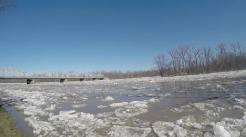 Ice flow of giant chunks moving down river towards bridge Video stock 49742836
