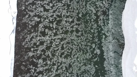 Ice flowing down river in winter from above Stock Footage 310572228