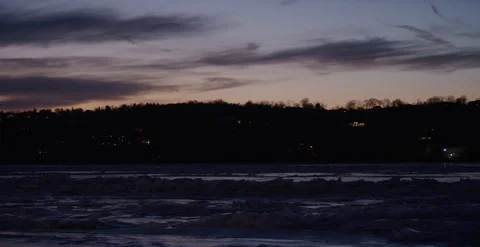 Ice flowing over the Hudson River in upstate New York at sunset dusk. Very color Stock Footage 249259194