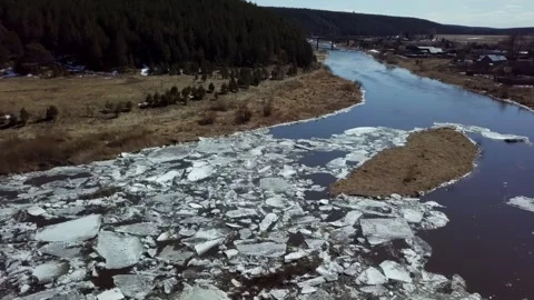 The Ice Flowing River flows through a vibrant Spring Landscape showcasing 库存影片 291585208