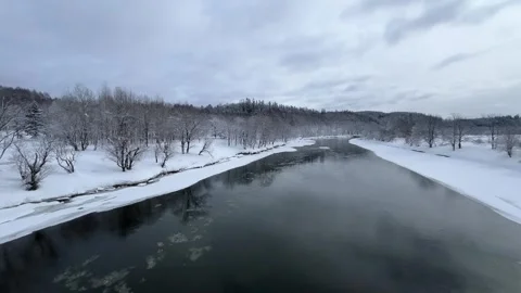 Ice flowing on a wide flat river in a snowy winter landscape Stock Footage 327654243