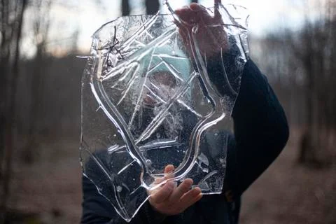 Ice in the forest. Ice in the hands. Stock Photos