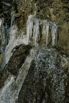 Ice formations on rocky surface create a stunning winter landscape in a serene Stock Photos