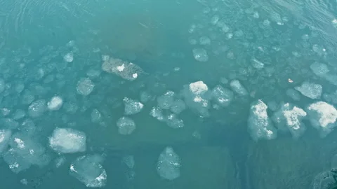 Ice forms float on blue water in a natural setting during the day, creating a Stock Footage 331326082
