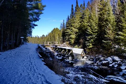 Ice forms in winter along a water sluice Stock Photos