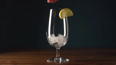 Ice in a glass on a dark background. making a cocktail Stock Footage 165296184