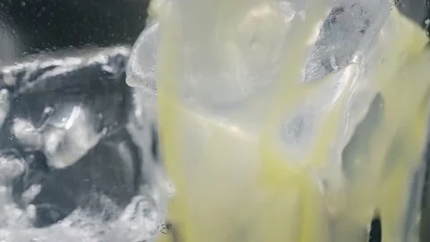 Ice in a glass of juice. Macro Stock Footage 152167985