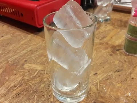 Ice in the glass on the table Stock Photos