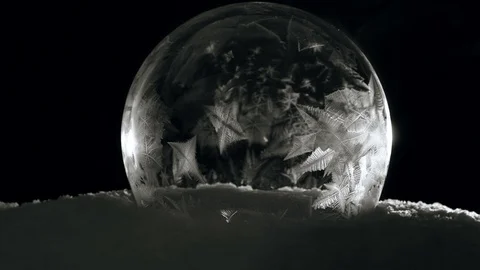 Ice globe freezing in in cold winter morning on black background Stock-Footage 119253021