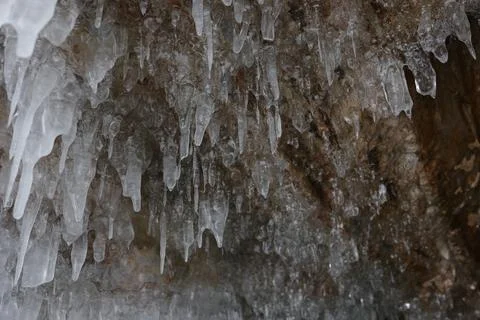Ice hangs in long drops in a cave Foto stock