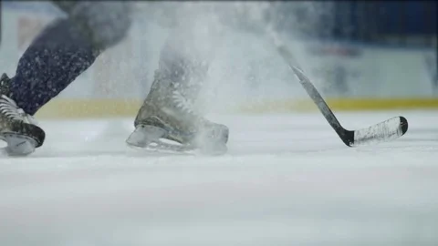 Ice hockey. Close-up of hockey skates. The hockey player does the braking on the Stock Footage