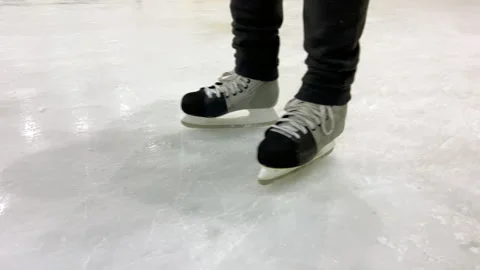 Ice hockey player practicing skating on ice rink Stock Footage 311476579