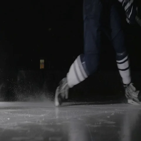 Ice hockey player shoots the puck, power slap shot in canadian style by Stock Footage