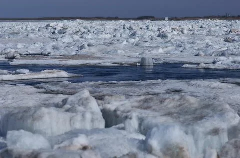 Ice hummocks on the river in spring. There is a funnel on the water in the sh Stock Photos