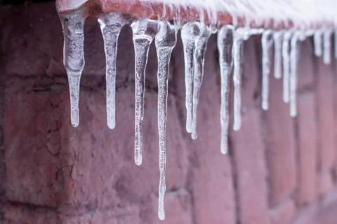 Ice icicle on the edge of the eaves. Stock Photos