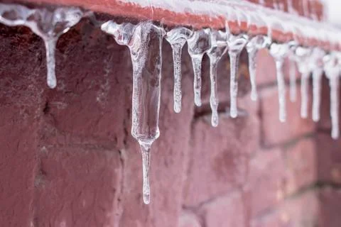 Ice icicle on the edge of the eaves. Stock Photos