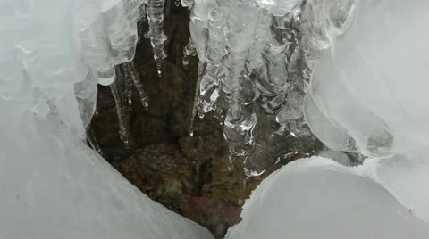 Ice icicles flow melt water drop stones mountain cave Stock Footage 22376371