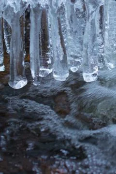 Ice, icicles in water Stock Photos