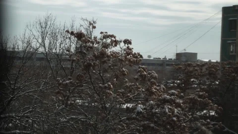 Ice icicles on the window against the background of the winter sky and the city. Stock Footage 271230025