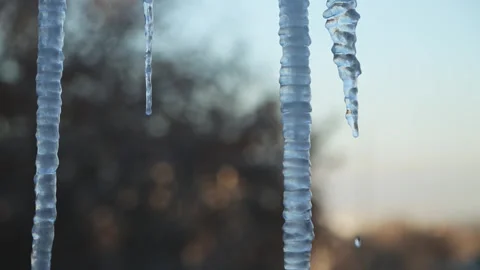Ice icicles on the window against the background of the winter sky and the city. Stock Footage 271230167