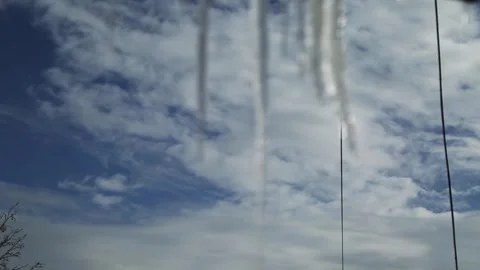 Ice icicles on the window against the background of the winter sky and the city. Stock Footage 278258150